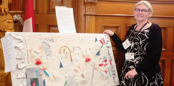 Dr. Sheila Thompson beside catheter artwork