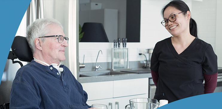 Older gentleman in wheelchair with his attendant.