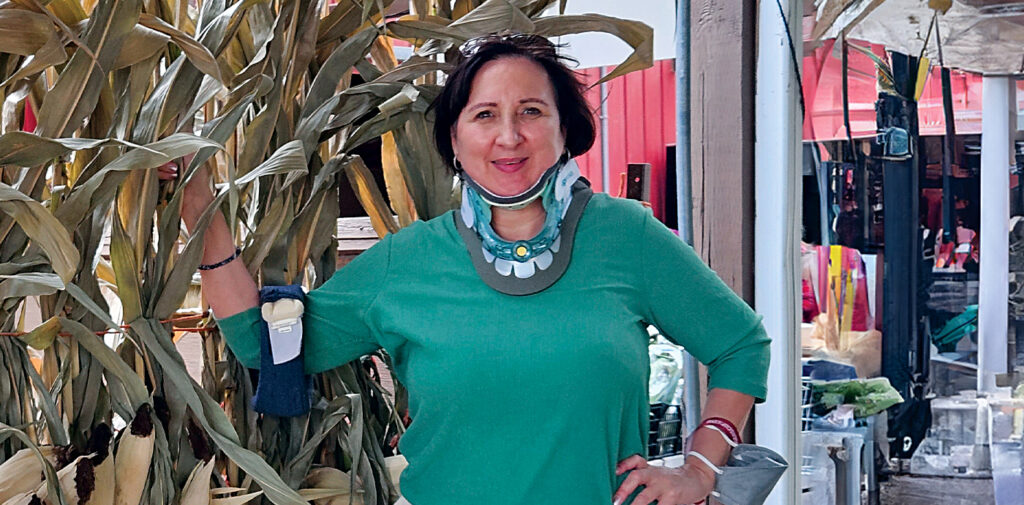 Anthina Hall standing outside in front of a corn field.