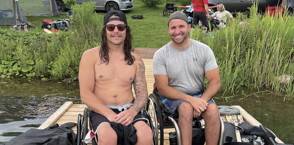 Two SCIO community members pose on the dock as they await their turn for sit-skiing.
