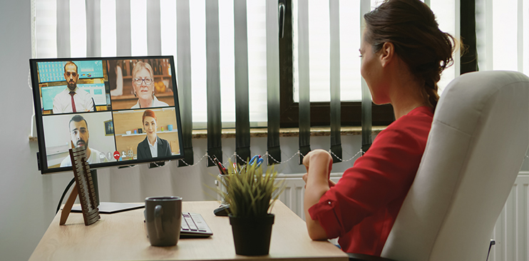 Woman conducting mediation session online with four clients.