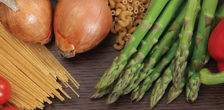 Anarray of healthy foods including asparagus, pasta, onions and tomatoes